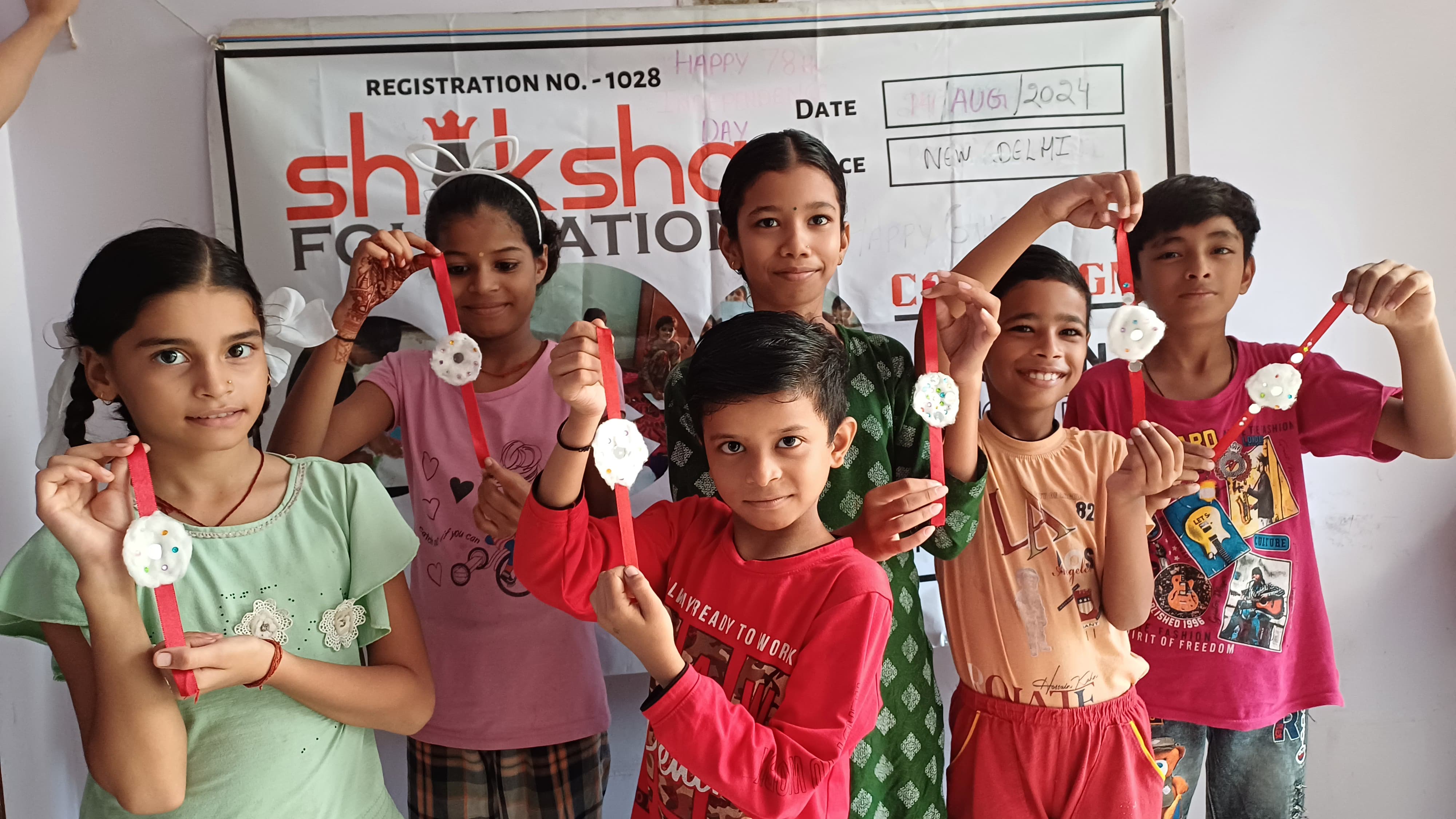 Rakhi being tied on a child's wrist during the celebration